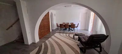 a room with an archway with chairs and a table at Vila Felicita in Sremski Karlovci