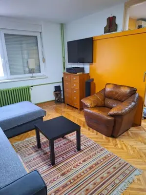 a living room with a leather couch and a table at Apartment Casper in Belgrade