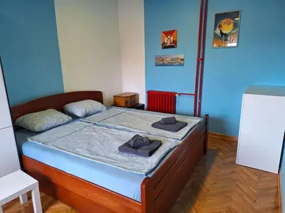 a bedroom with a bed with two hats on it at Apartment Casper in Belgrade