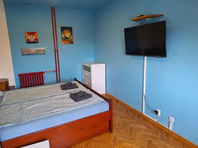 a bedroom with a bed and a flat screen tv at Apartment Casper in Belgrade