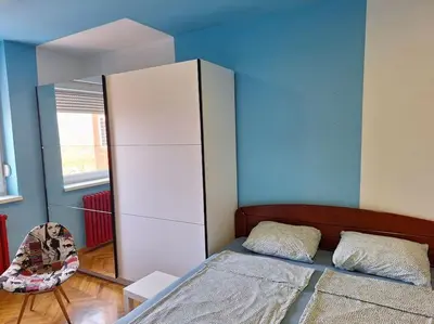 a bedroom with a bed and a white cabinet at Apartment Casper in Belgrade