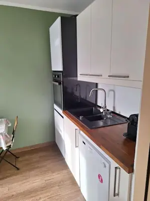 a kitchen with white cabinets and a sink at Apartment Casper in Belgrade