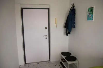 a white door in a room with a stool at Apartment Ivon in Belgrade