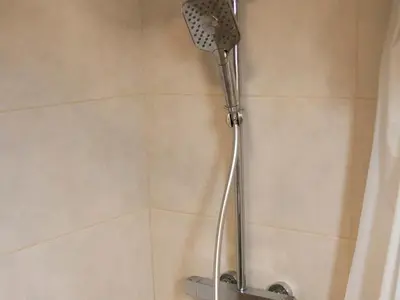 a shower with a shower head in a bathroom at Apartment Ivon in Belgrade