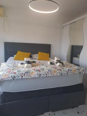 a bedroom with a large bed with shoes on it at Apartment Ivon in Belgrade