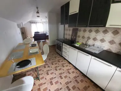 a kitchen with a table and a counter top at LB boka 216 in Mali Mokri Lug