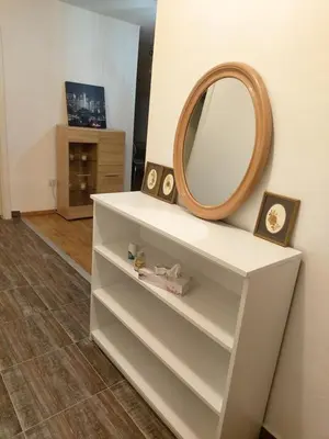a white dresser with a mirror on top of it at LB boka 216 in Mali Mokri Lug