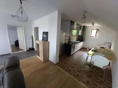 a living room with a couch and a table at LB boka 216 in Mali Mokri Lug