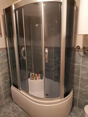 a shower with a glass door in a bathroom at LB boka 216 in Mali Mokri Lug