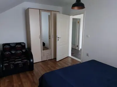 a bedroom with a bed and a chair and a mirror at LB boka 216 in Mali Mokri Lug