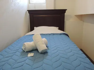 a bed with two towels on top of it at Apartmani Beograd 43 in Belgrade