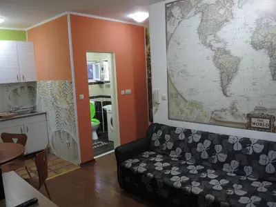 a living room with a couch and a map on the wall at Apartmani Beograd 43 in Belgrade