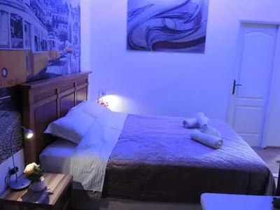 a bedroom with a bed with a teddy bear on it at Apartmani Beograd 43 in Belgrade