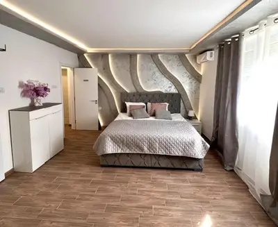 a bedroom with a large bed in a room at S class apartment in Novi Grad
