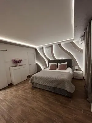 a bedroom with a large bed with a curved ceiling at S class apartment in Novi Grad
