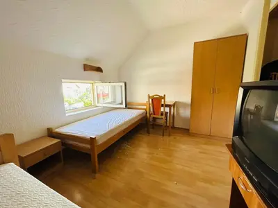 a small bedroom with a bed and a window at Rooms for rent 