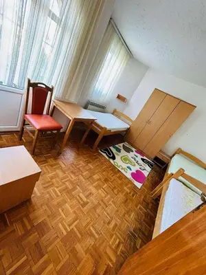 a room with a table and two chairs and a desk at Rooms for rent 