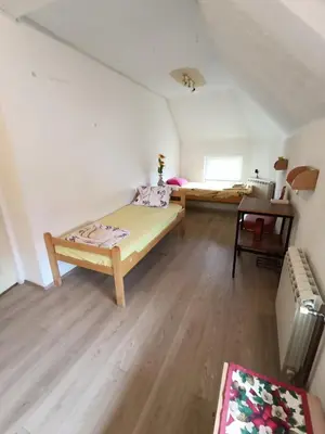 a bedroom with a bed and a desk in a room at Rooms for rent 