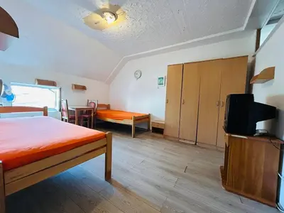 a bedroom with a bed and a tv in a room at Rooms for rent 