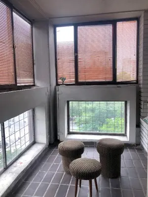 a room with four windows and three stools at Maki NBG in Belgrade