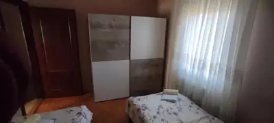 a small bedroom with a bed and a window at Apartman Irena in Mali Mokri Lug
