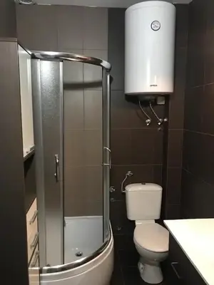a bathroom with a toilet and a glass shower at Apartman Irena in Mali Mokri Lug