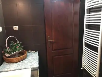 a bathroom with a basket on a counter next to a door at Apartman Irena in Mali Mokri Lug
