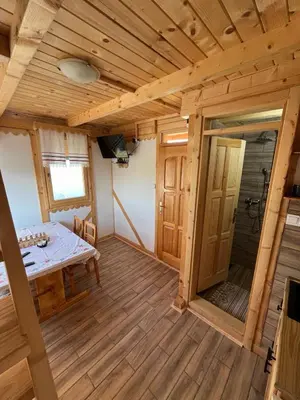 a small room with a table and a shower at Kućica naša bajka in Kupinovo