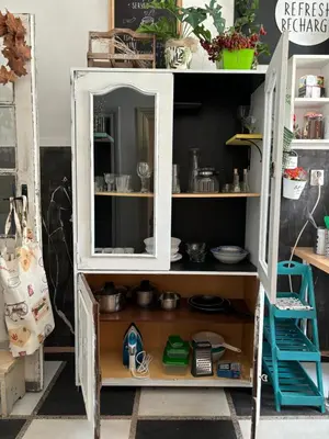 a white cabinet with a mirror in a room at Creative Apartment Kaleidoscope in Belgrade