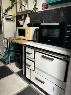 a kitchen with a microwave on top of a stove at Creative Apartment Kaleidoscope in Belgrade