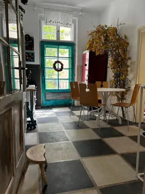 a living room with a table and chairs and a window at Creative Apartment Kaleidoscope in Belgrade