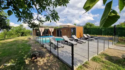 a swimming pool with lounge chairs next to a house at Niki Hill in Sremski Karlovci