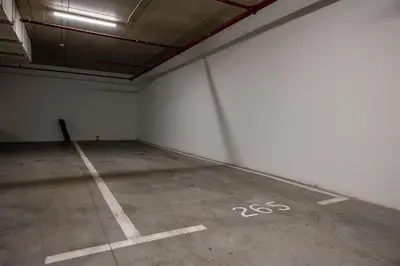 an empty room with a white wall and a parking lot at Modern apartment on the Belgrade Waterfront in Belgrade