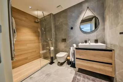 a bathroom with a toilet and a sink and a mirror at Modern apartment on the Belgrade Waterfront in Belgrade