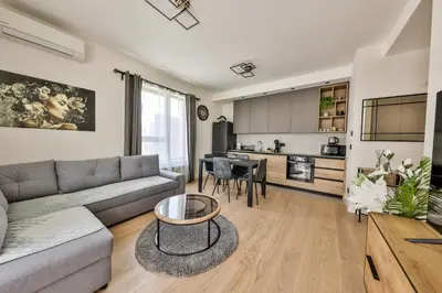 a living room with a couch and a table at Modern apartment on the Belgrade Waterfront in Belgrade