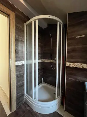 a shower with a glass door in a bathroom at Apartman 24 in Arandjelovac
