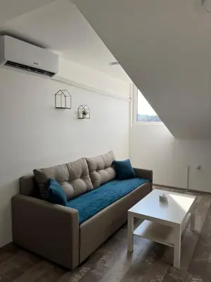 a living room with a couch and a table at Apartman 24 in Arandjelovac