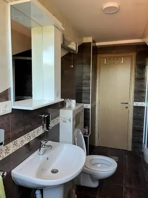 a bathroom with a white sink and a toilet at Apartman 24 in Arandjelovac