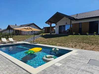 a swimming pool with a toy turtle and an inflatable at K42 pool house in Vlasi