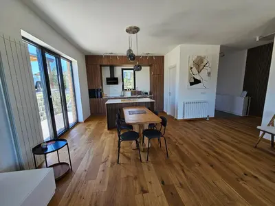 a kitchen and dining room with a table and chairs at K42 pool house in Vlasi