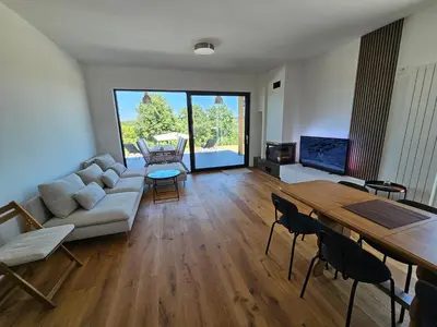 a living room with a couch and a table at K42 pool house in Vlasi
