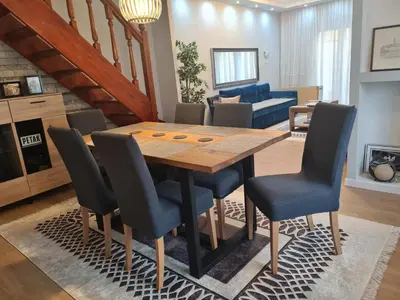 a dining room with a wooden table and chairs at Apartment Roosevelt in Belgrade