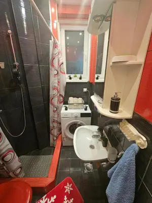 a small bathroom with a toilet and a sink at Alexis Apartman in Belgrade
