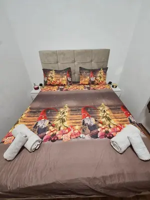 a bed with two pairs of socks on it at Kalina Apartman in Belgrade
