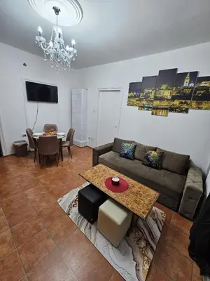 a living room with a couch and a table at Kalina Apartman in Belgrade