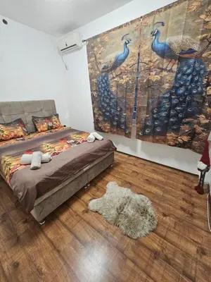 a bedroom with a bed and a painting on the wall at Kalina Apartman in Belgrade