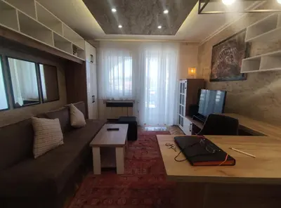 a living room with a couch and a table at Apartman Osmeha in Mladenovac
