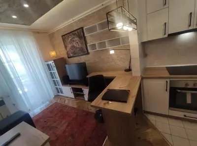a kitchen with a table with a laptop on it at Apartman Osmeha in Mladenovac