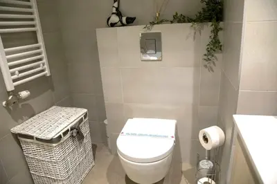 a small bathroom with a toilet and a trash can at Apartment BW Maria Belgrade in Sajmište