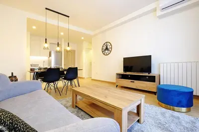 a living room with a couch and a tv and a table at Apartment BW Maria Belgrade in Sajmište